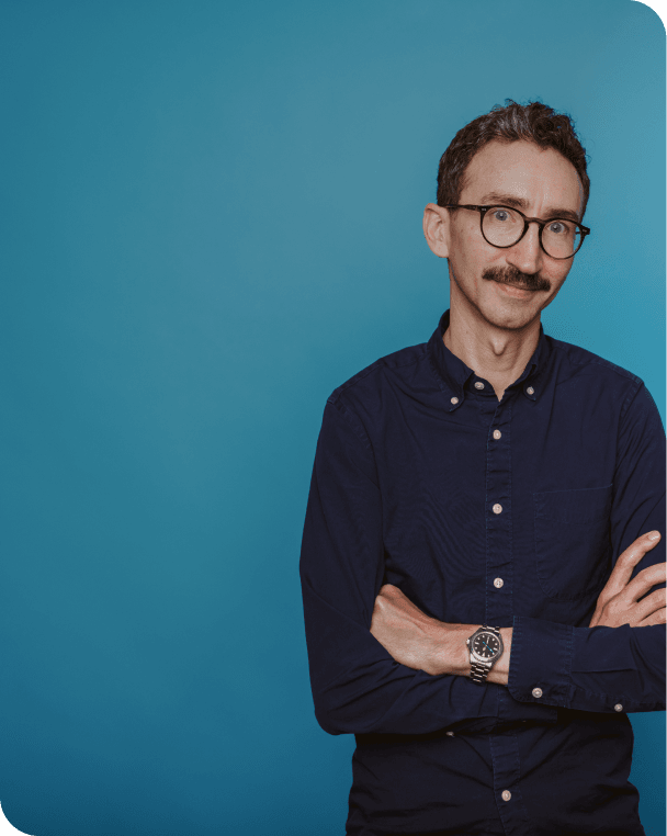 Man smiling with arms crossed