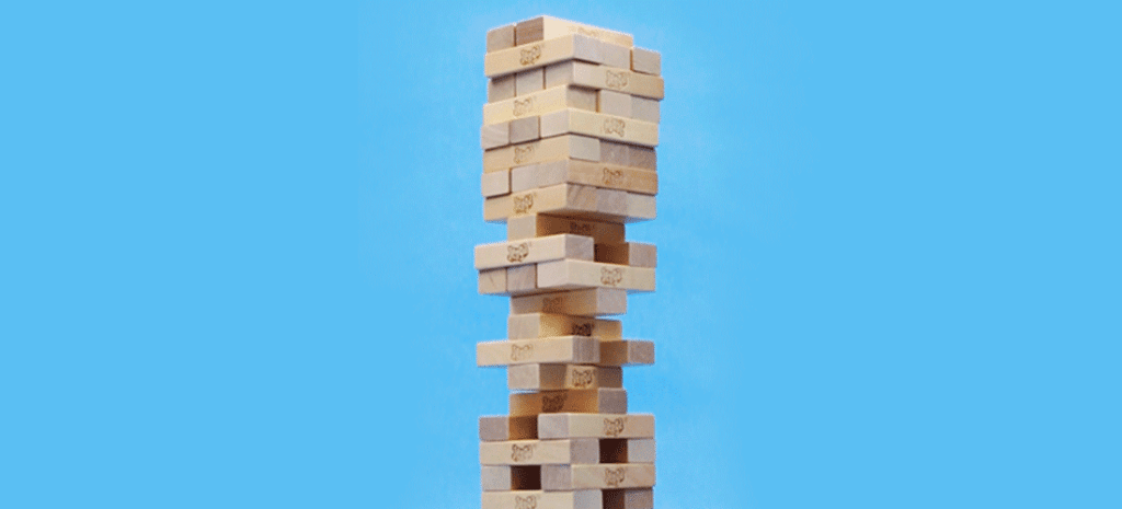 Jenga tower on blue background