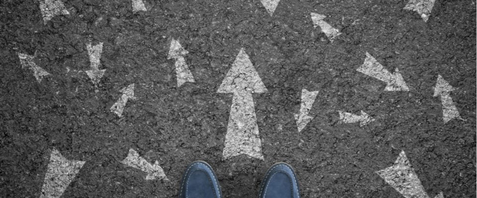 Photograph taken from above of a blue pair of shoes facing out to customer journey arrows