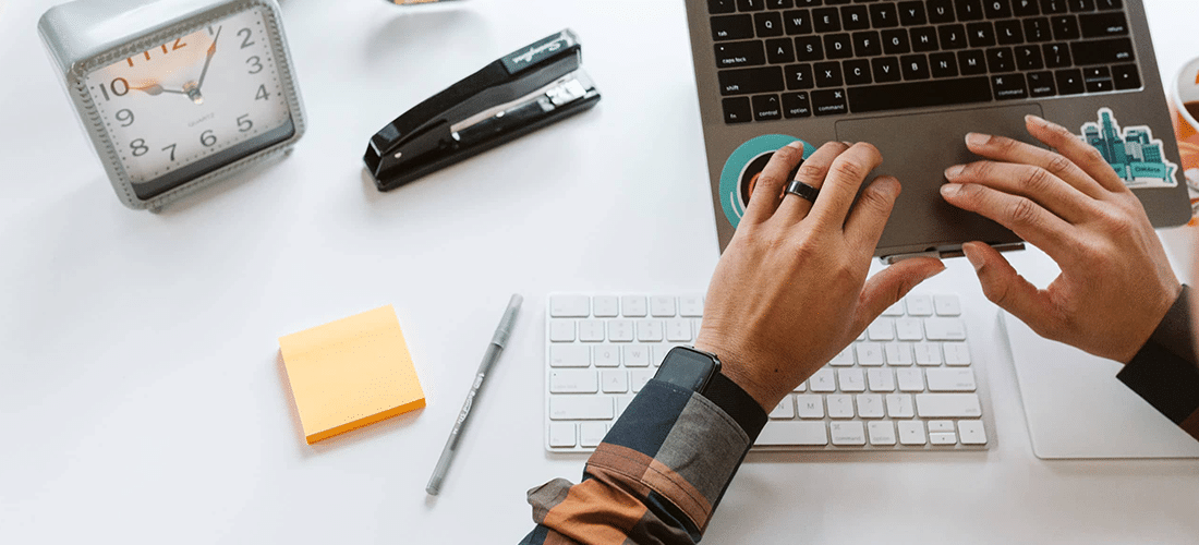a man works on a laptop on an elevated laptop stand