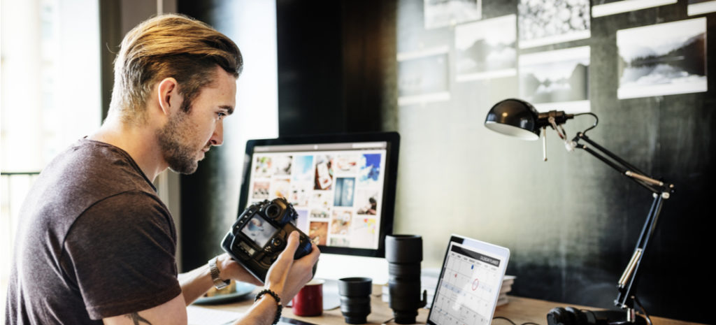 male photographer holding camera