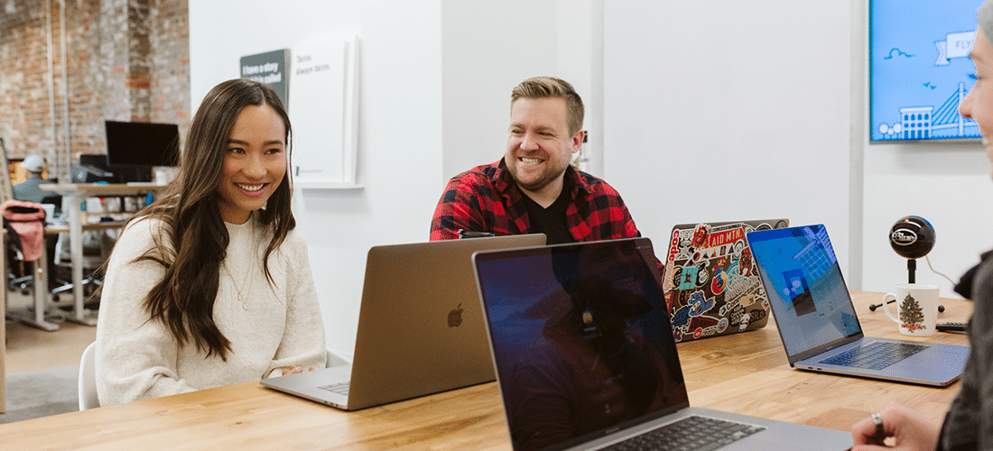 coworkers share a laugh while working on a project