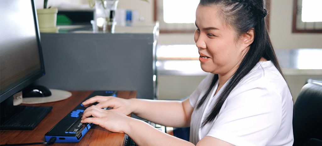 Visually impaired women using braille-enabled keyboard