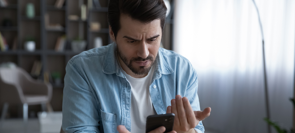man upset about website functionality on mobile device