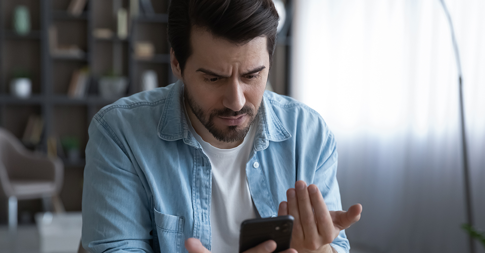 man upset about website functionality on mobile device