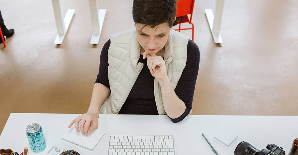 a person working at a desk seriously considers their relationship with a client