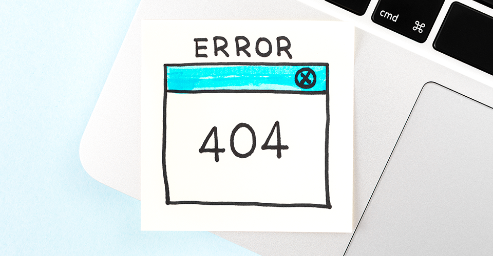 How to set up redirects in WordPress. Image depicts the corner of a laptop. There is a sticky note on it that reads Error 404