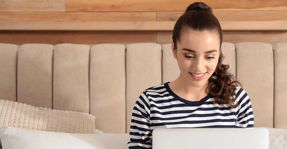 a woman in a striped sweater works on a design