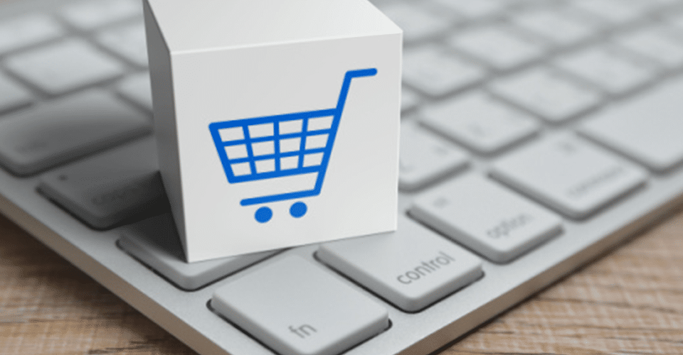 eCommerce shopping cart icon on top of a keyboard