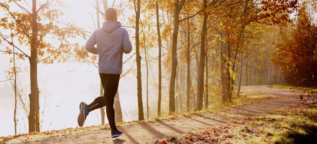 5 Ways to Reduce Initial Server Response Time. person in hoodie running in morning light on trail