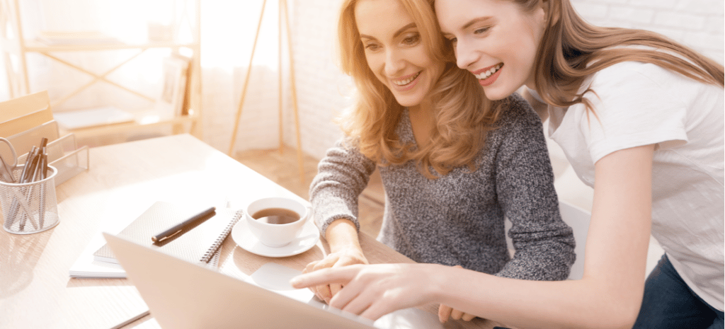 Teenage girl and mom working on a laptop together