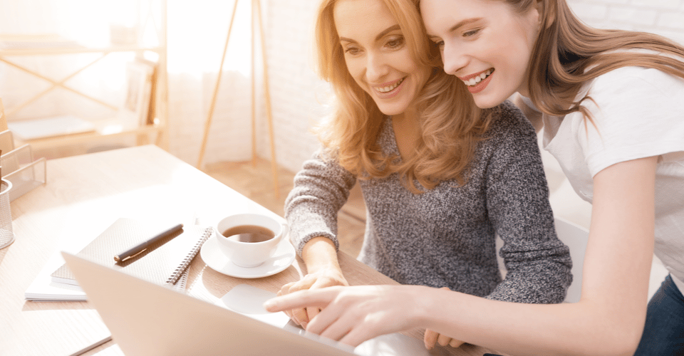 Teenage girl and mom working on a laptop together