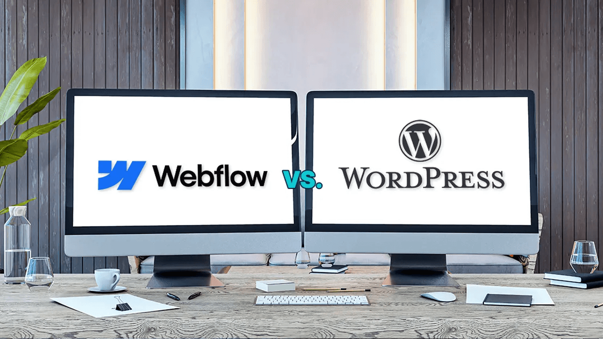 An image of two computer monitors, one with the Webflow logo and the other with the WordPress logo.