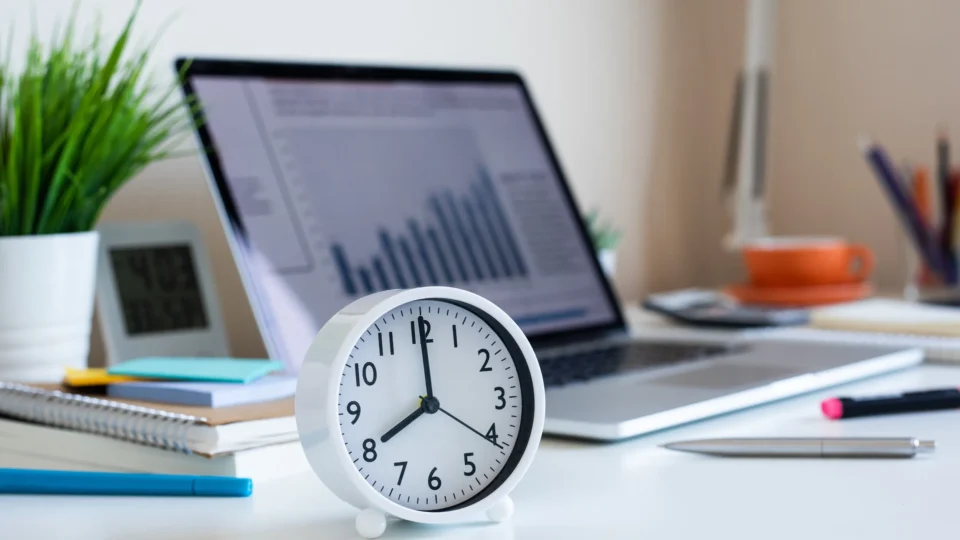 An agency tries to maximize billable hours by keeping an analog clock next to the laptop on their desk.